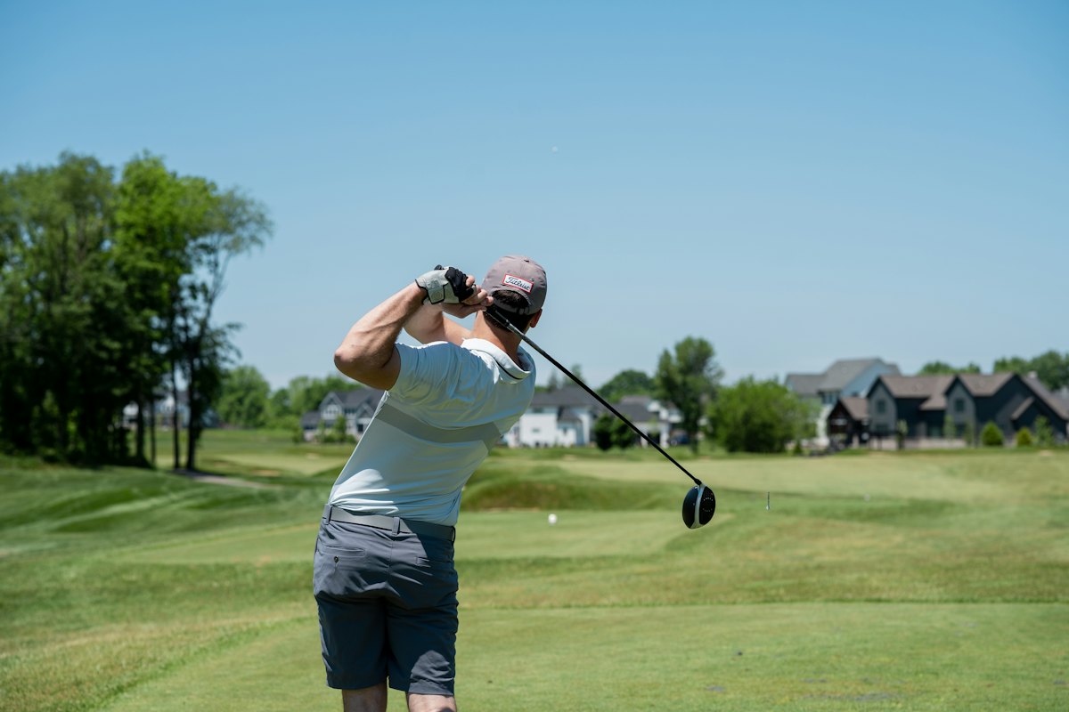 A golfer following through on a swing