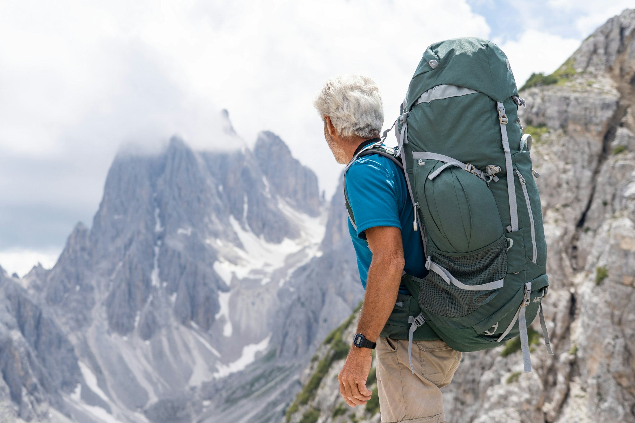 An older hiker looking out across the mountains